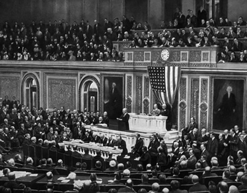 An old black and white image showing Woodrow Wilson delivering his war message