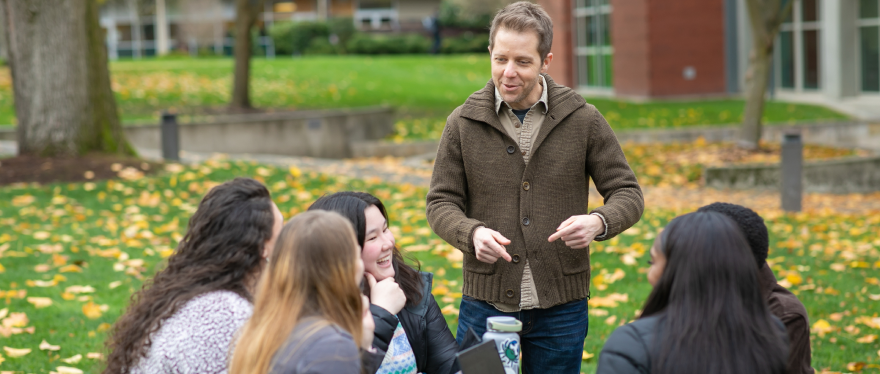 Professor of Psychology and Biology Baine Craft talks  with a few of his students from the first cohort of the Master of Science in Research Psychology program.