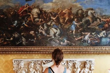 While studying abroad in Europe, this student stands before a painting in a museum.