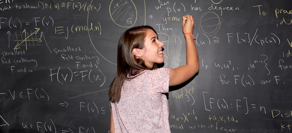 Student in front of chalkboard