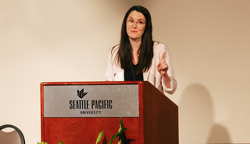 Dr. Annie Kato Speaking at a Podium