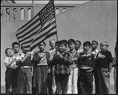 Children raise the American flag in an internment camp