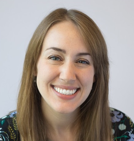 headshot of christy barnes straight brown hair and black floral shirt