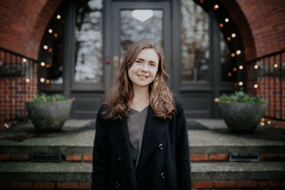 Taylor Pearson, Seattle Pacific Seminary student, standing in front of Alexander and Adelaide Hall