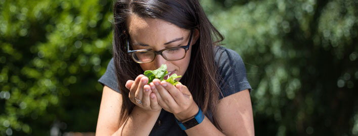 girl smells plants