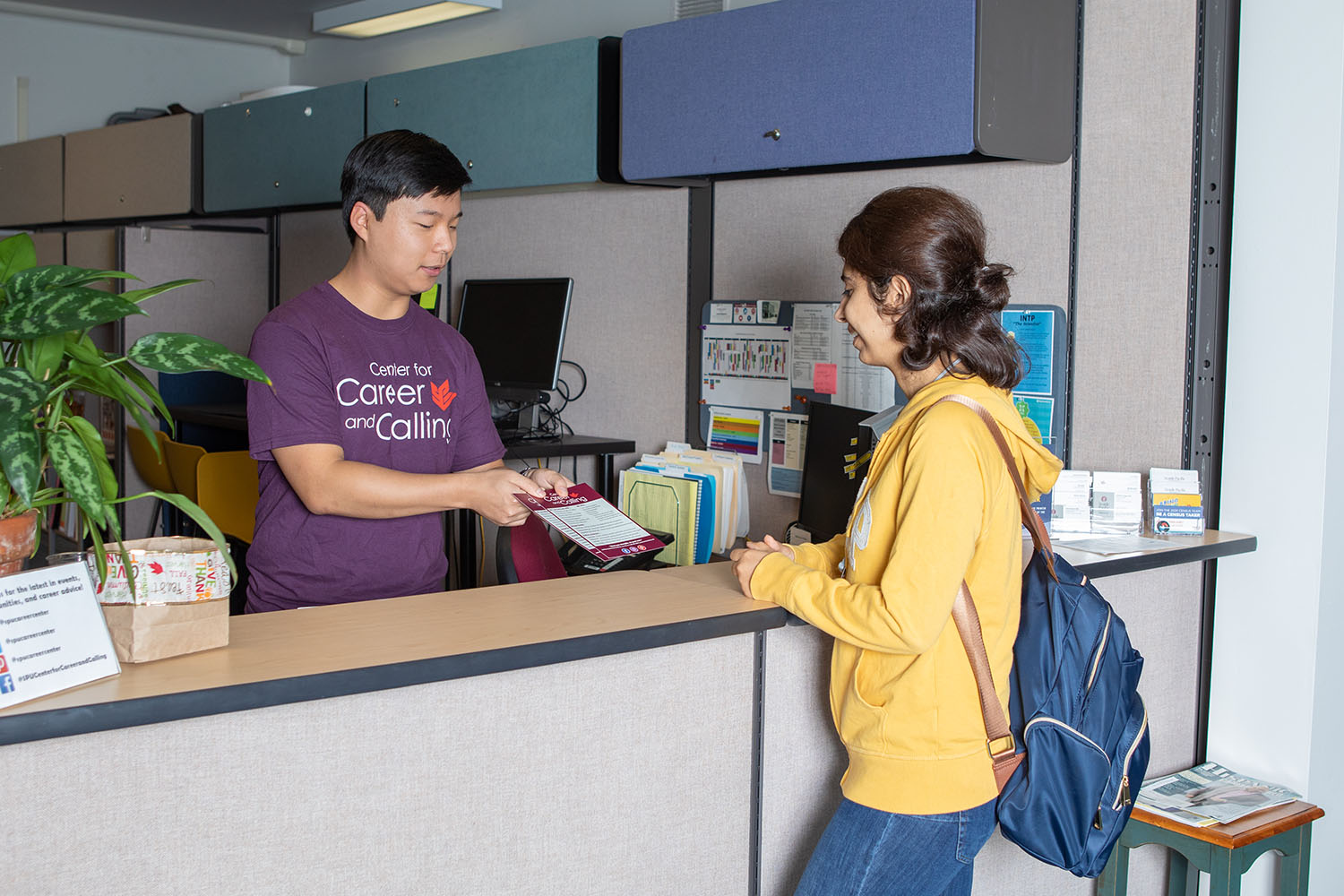 A peer career advisor helps a student in a walk-in session