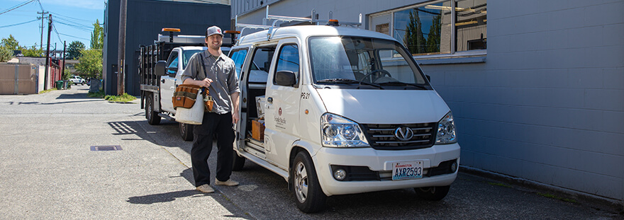 SPU facilities staff member next to an SPU service vehicle