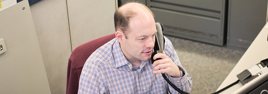 An Student Financial Services employee answers the phone | photo by Chris Yang