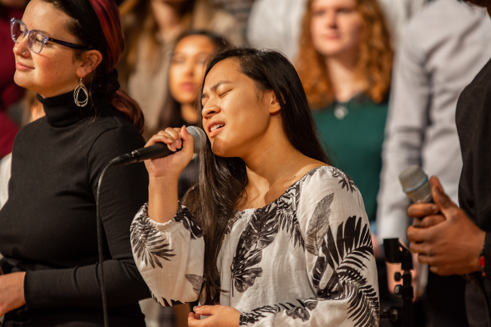 SPU student on the Worship Team singing in Chapel