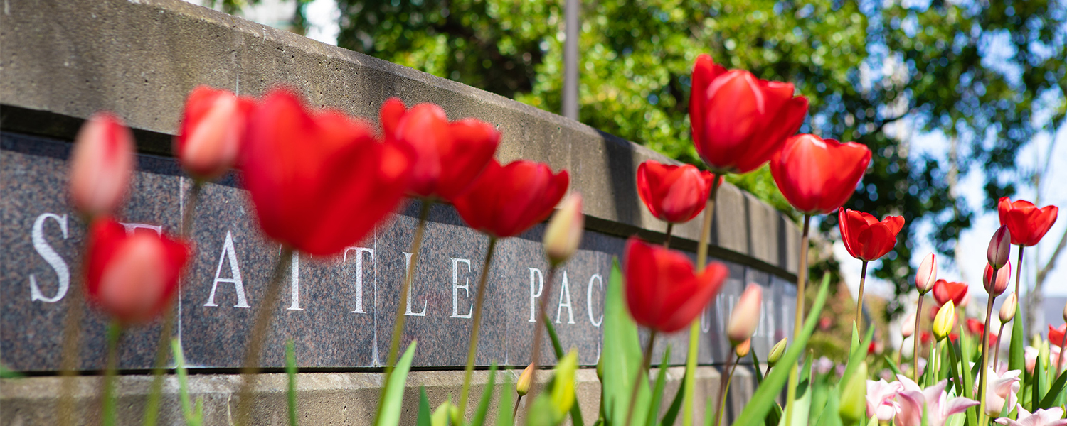 Seattle Pacific Sign behind flowers