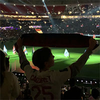 A fan shows support during an Olympique Lyonnais football game | photo by Andrew Macpherson