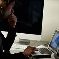 An SPU student works at a laptop