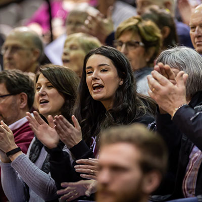 A student cheers on the men's basketball team during Homecoming weekend