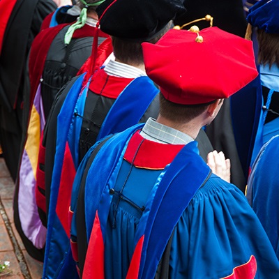 A rear-view image of SPU faculty members in regalia