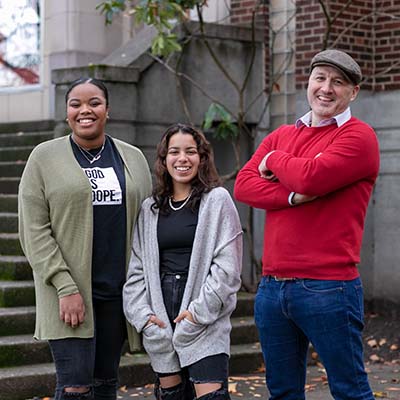 Dr. Misha Willet (far right) stands with two students in Tiffany Loop.