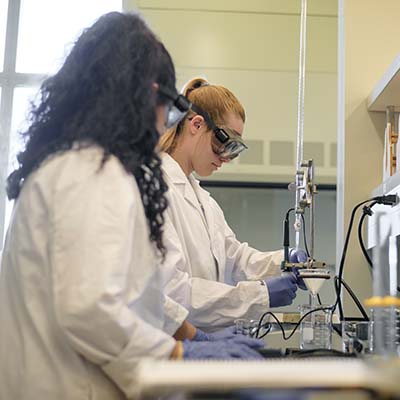 Two female STEM students working in a lab in the Eaton Science Building.