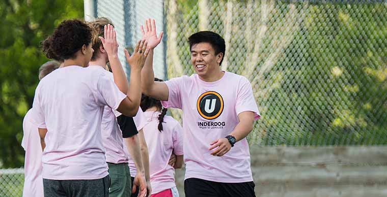 Students shown high giving each other during a sports game