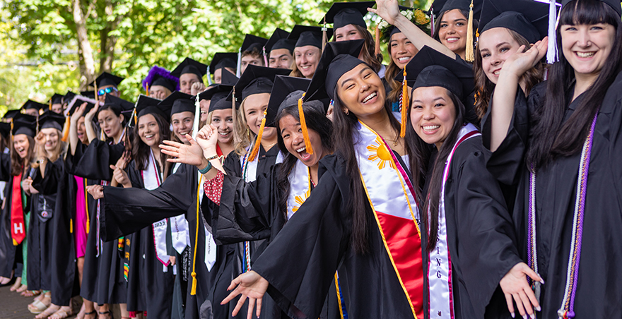 Excited students in their caps and gowns wait for SPU