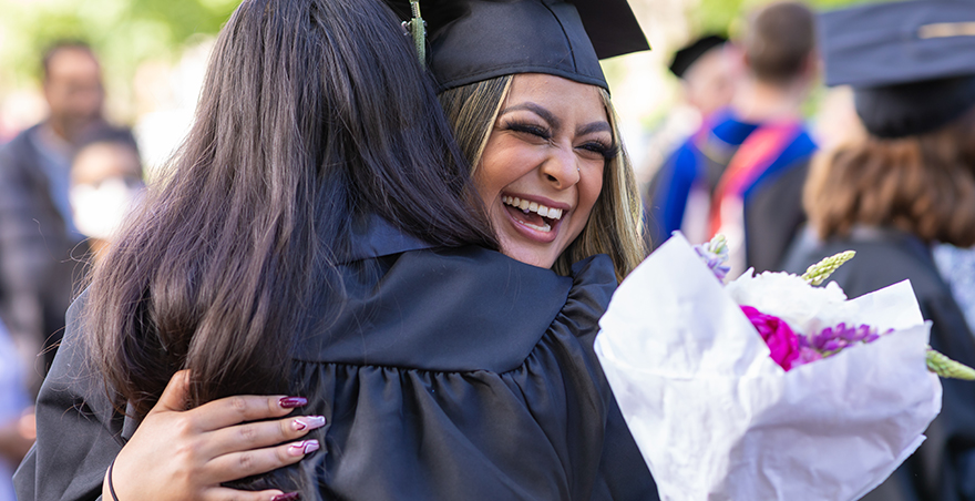 Two friends hug after SPU