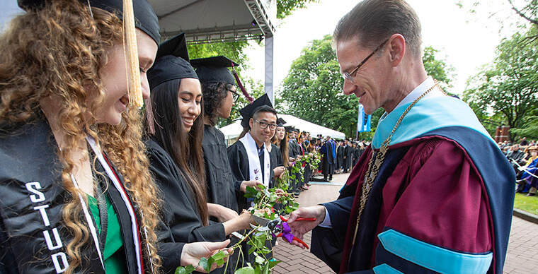 President Dan Martin cuts the ivy for a group of SPU graduates - photo by Mike Siegel